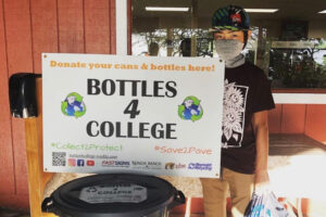 A boy holding a board for Donation