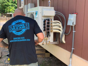 a man fixing the ac machine